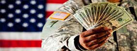 Soldier holding money saved with a VA Refinance